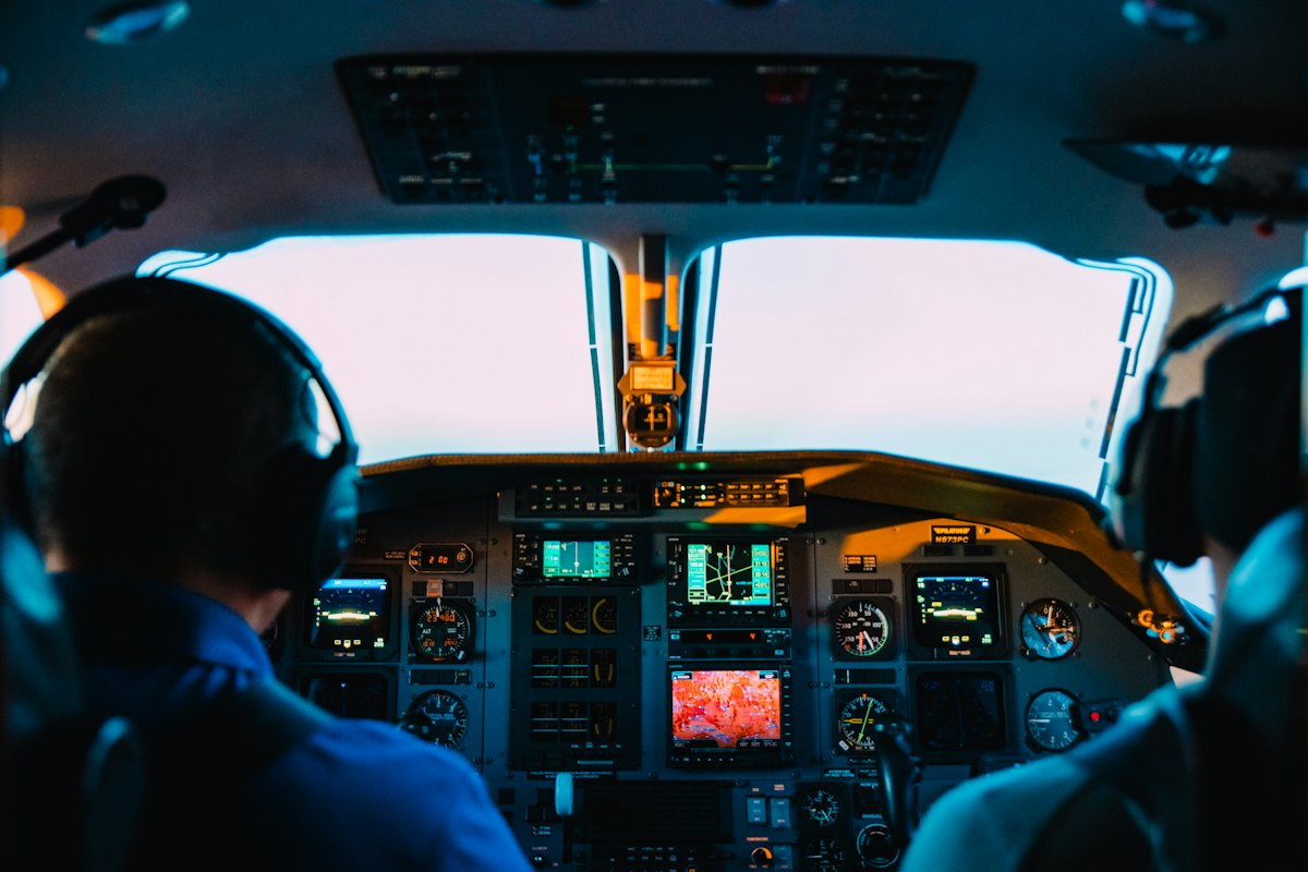 Pilots in the cockpit at sunset